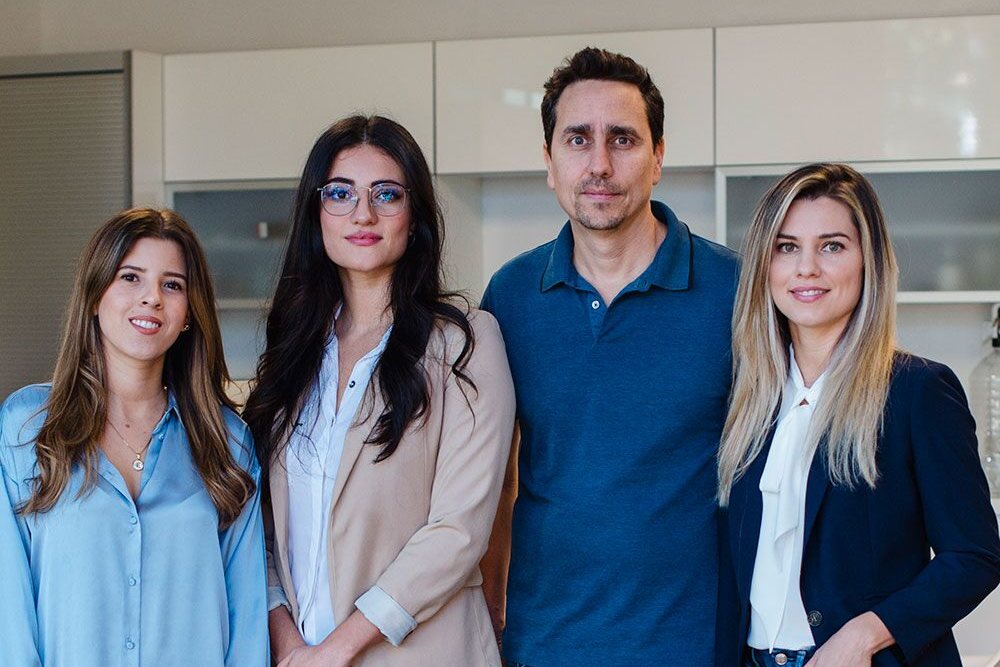 Four members of the LawRank team standing together in the office